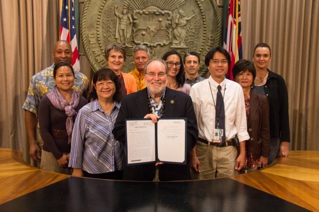 Governor Abercrombie and a group of people posing