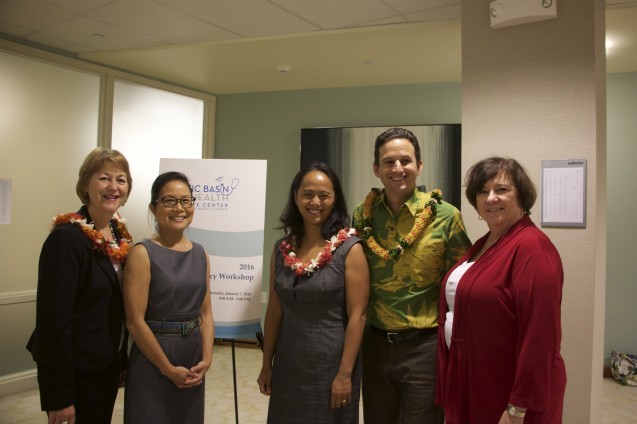 Four women and one man posing and smiling