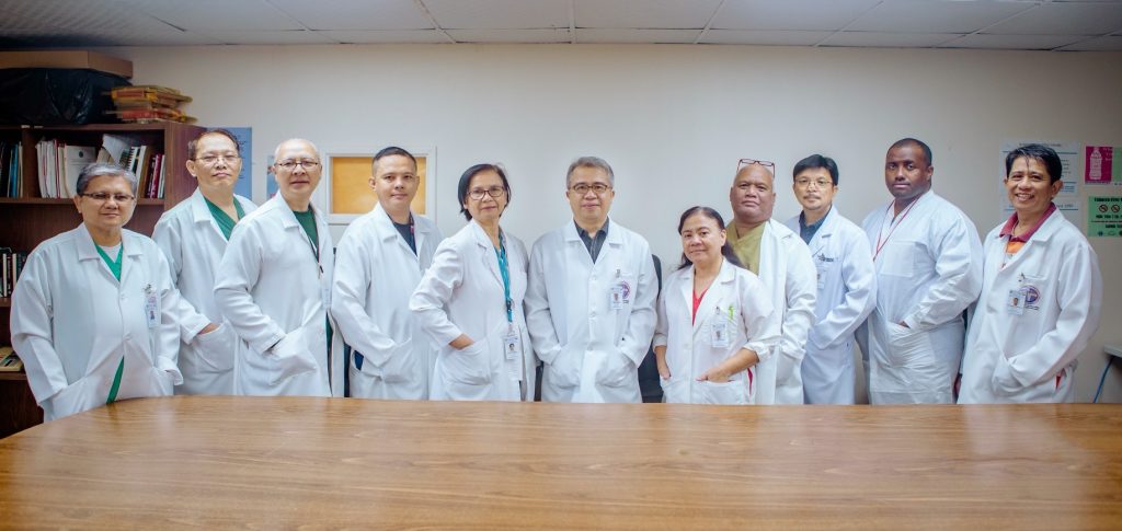 Group of men and women in white lab coats