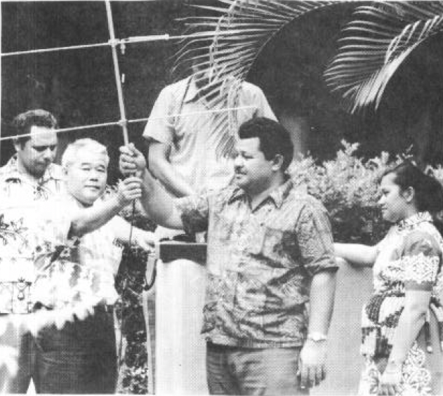 Four men and one woman holding a satellite