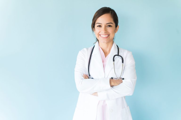 Female doctor in white coat smiling
